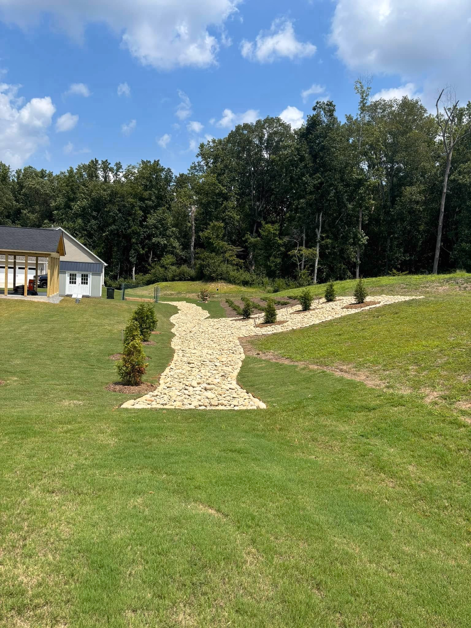 Terraced retaining wall with steps cut into a sloped yard.